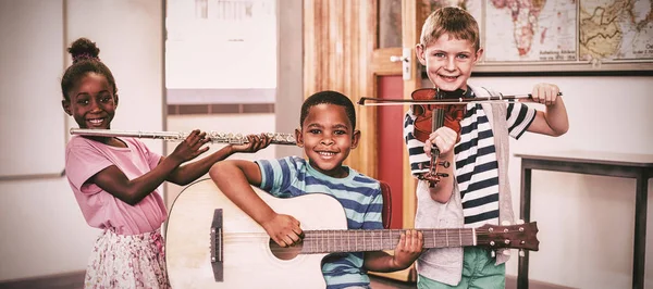在学校课堂上演奏乐器的微笑的孩子们的肖像 — 图库照片