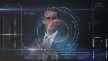 Yakışıklı genç işadamı ofiste karanlık odada dijital ekran kullanarak dijital bileşik. Çubuk grafik grafik ile dijital ekran gösterir