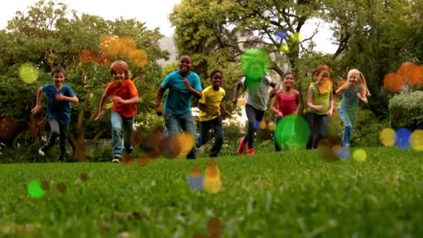 在前景有光泡的公园里 学校孩子慢动作向摄像机跑去的低视角 — 图库视频影像