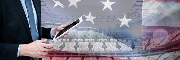 アメリカの国旗のクローズ アップに対してタブレット コンピューターを保持している実業家 — ストック写真