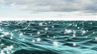 Bokeh ışıkları ön planda görünürken gökyüzünün altında sallanan okyanusun yakın görünümü