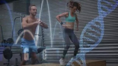 Spor salonunda egzersiz beyaz erkek ve kadın dijital kompozit. DNA sarimi ve kalp monitörü ön planda görülüyor