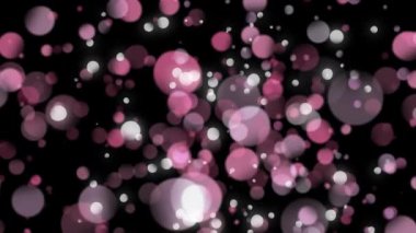 Siyah arka plana karşı ekrana yakınlaştırılan ve çıkan bokeh ışıklarının dijital olarak oluşturulmuş animasyonu.