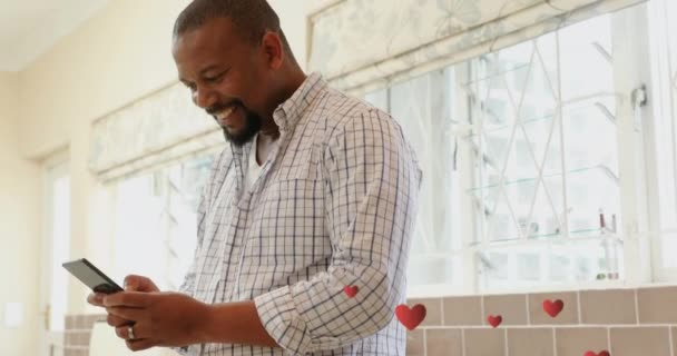 Digital Animation African American Man Texting Smiling Kitchen Floating Hearts — Stock Video