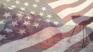 Bir ızgara yanında bir plajda asılı arkadaş dijital kompozit ve ön planda rüzgar karşı sallayarak bir Amerikan bayrağı