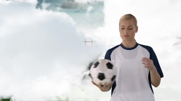 一名白人足球运动员在数字生成的球场内检查球的特写 — 图库视频影像