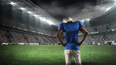 Dijital ortamda üretilen bir stadyumda dikilen Afro-Amerikan futbolcunun arka görüntüsü.