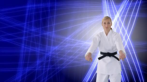 青と白の輝く線の背景で空手をしている白人女性のデジタルコンポジット — ストック動画
