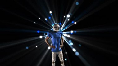 Beyaz-Amerikalı bir futbolcunun sol kolunu mavi ve beyaz bokeh ile kaldırma sının ve arka planda parlayan ışığın dijital bileşimi