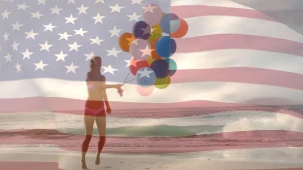 7月4日の背景にアメリカの旗が波立つ間 ビーチで風船を持つ白人女性のデジタルコンポジット — ストック動画