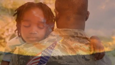 Amerikan bayrağı nı havada tutan afro-amerikan çocuğu taşıyan üniformalı Afro-Amerikan askerinin dijital bileşimi ve gökyüzünün arka planı bulutlarla.