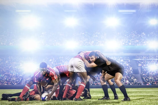 Rugby players scrum against digital image of crowded soccer stadium