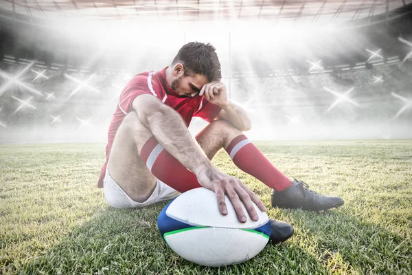 Caucasian male rugby player on field against rugby pitch