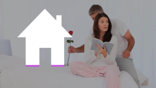 남성의 애니메이션은 침대에 독서를 여성에게 장미를 가져다주고 집안의 아이콘은 분홍색으로 — 비디오