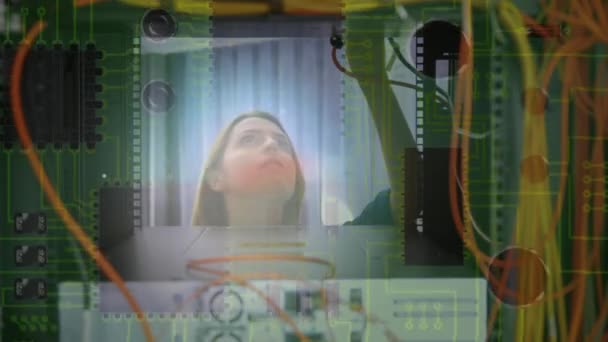 一个在计算机服务器上工作的高加索女人的动画从服务器机架里面看到的很近 而计算机电路板的背景在后面移动 — 图库视频影像