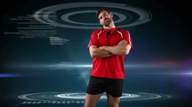 Beyaz bir erkek rugby oyuncusu nun çapraz kollarıyla ayakta durması ve koyu mavi bir arka plan üzerinde görünen tıbbi verilerle kameraya bakması