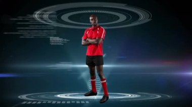 Çapraz kolları ile ayakta ve koyu mavi arka planda görünen tıbbi veriler ile kameraya bakarak bir Afrikalı-Amerikalı erkek rugby oyuncusu Animasyon
