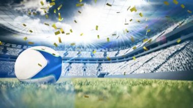 Altın konfeti düşen bir rugby sahası üzerine yerleştirilen bir rugby topu yakın çekim animasyon