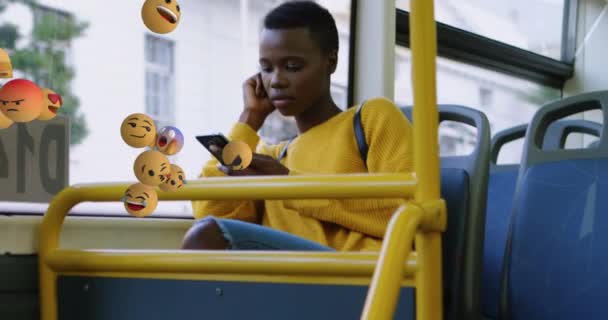 Animación Iconos Emoji Volando Con Una Joven Afroamericana Usando Teléfono — Vídeos de Stock