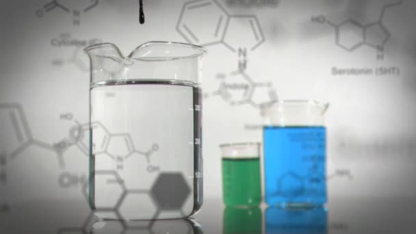 전경에 화합물의 데이터 공식으로 착색된 액체로 채워지는 3개의 실험실 비커의 — 비디오