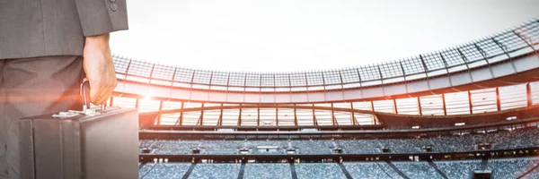 Empresário Segurando Pasta Contra Estádio Rugby Amanhecer — Fotografia de Stock