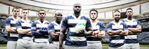 Rugby Team against rugby goal post on a sunny day in the stadium