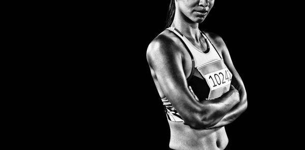 Tough female sprinter isolated on black background 