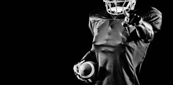 强大的橄榄球运动员孤立在黑色背景 — 图库照片