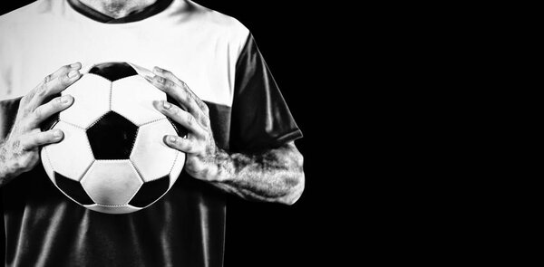 Focused Soccer Player isolated on black background 