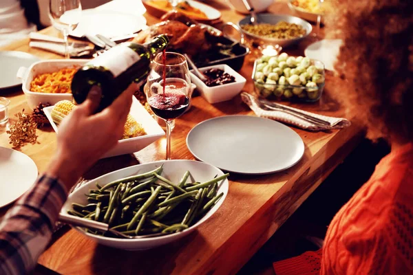 Shoulder View Man Sitting Table Home Set Thanksgiving Dinner Pouring — Stockfoto