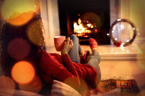 Composite image of brown parquet against woman at home at christmas time