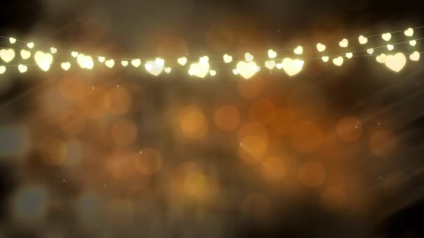 背景に動く光のオレンジ色の輝きを持つ輝くハート型の妖精の光の文字列を持つクリスマスの装飾のアニメーション — ストック動画