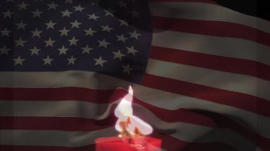 Arka planda dalgalanan Amerikan bayrağıyla yanan bir mum animasyonu