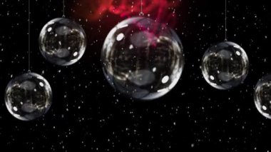 Kar yağışının animasyonu ve parlak arka planda cam takılar olan Noel süslemeleri