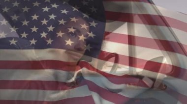 Amerikan bayrağının arabada oturan melez bir kadının üzerinde dalgalanması. Amerika Birleşik Devletleri bayrağı ve tatil konsepti dijital kompozisyon