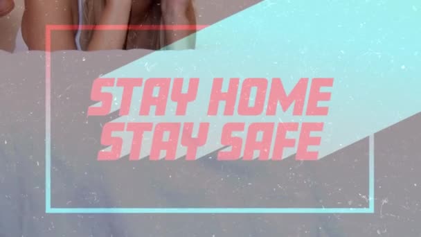 Animación Palabras Stay Home Stay Safe Frame Caucasian Woman Listening — Vídeo de stock