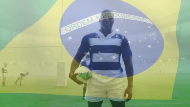 Animacja Brazylijskiej Flagi Machającej Nad Afro Amerykańskim Graczem Rugby Trzymającym — Wideo stockowe
