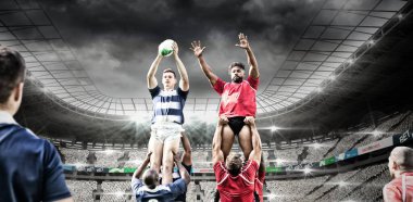 Çok ırklı rugby oyuncularından oluşan iki takım bir spor stadyumunda rugby oynuyor, takım elbiseleri giyiyor, takım arkadaşları tarafından tutulan topu yakalıyorlar, dijital kompozit..