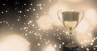 Siyah zemin üzerinde yüzen beyaz şekilli, beyaz ışıklı dijital kompozisyonu olan altın bir bardağın animasyonu