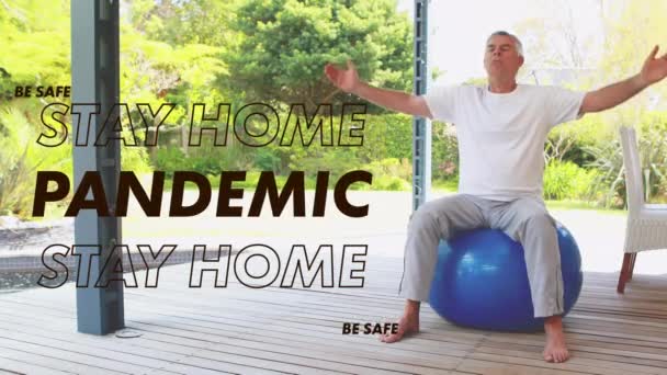 Animación Palabras Stay Home Pandemic Caucasian Man Stretching Swiss Ball — Vídeos de Stock