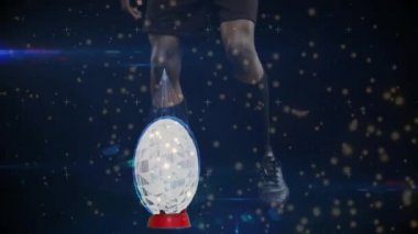 Rugby oyuncusunun bacaklarının üzerinde süzülen ışık lekelerinin animasyonu rugby topunu bir stanttan tekmeliyor ve mavi şekiller koyu arkaplanda, dijital kompozitte etkiyi gösteriyor.