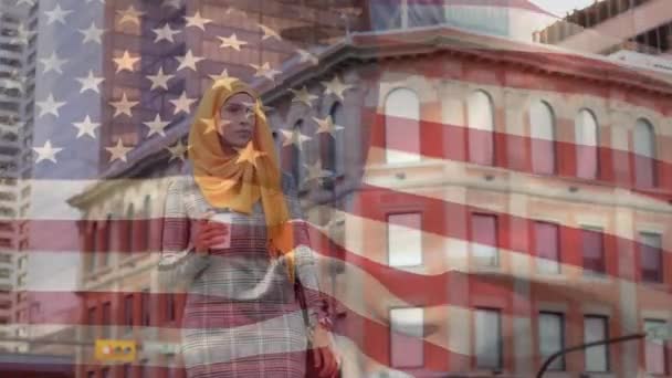 美国国旗飘扬在戴头巾的混血儿身上 手持外卖咖啡杯 在她的手表前查看时间 美国社会多样性概念数字构成 — 图库视频影像