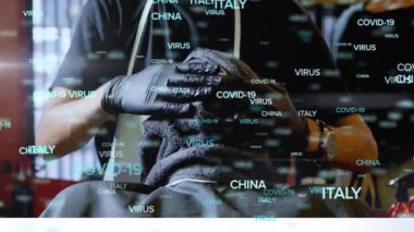 Covid 19 kelimesinin animasyonu, Virüs ve berber üzerinde hareket eden ülkelerin isimleri bir berber dükkanında havluyla erkek müşterinin yüzünü tedavi ediyor. Salgın dijital bileşim sırasında küçük işletmeler çalışıyor.