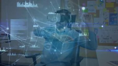 Sanal gerçeklik kulaklığı takan bir adamın ofisinde sanal arayüzü kullanarak hareket eden bağlı ikonlar ve veri ağının animasyonu. Dijital arayüz VR konsepti, dijital bileşik.