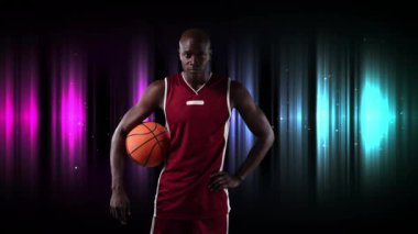 Erkek basketbolcunun çok renkli arka planda basketbol topunu tutarken çekilmiş dijital video. Spor fitness konsepti dijital kompozit