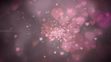 Pembe arka planda kusursuz bir döngü içinde hipnotik hareketlerle hareket eden parlak pembe kalplerin animasyonu. Renk ve hareket kavramı dijital olarak oluşturuldu.