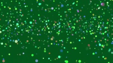 Yeşil arka plan üzerinde hipnotik hareket eden birden fazla parlayan yeşil ve mavi noktaların animasyonu. Renk ışığı ve hareket kavramı dijital olarak oluşturuldu.