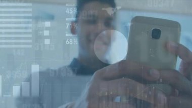 Akıllı telefon kullanan iki ırklı adamın diyagram ve veri işleme animasyonları. Küresel teknoloji ve dijital arayüz konsepti dijital olarak oluşturulmuş video.