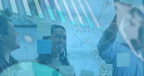 Image of financial data processing over diverse business people in office. Global business and digital interface concept digitally generated image.