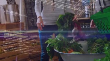 Animation of graph, trading board, binary codes, caucasian couple buying vegetable in supermarket. Digital composite, multiple exposure, love, togetherness, food and shopping concept.